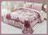 A double bed covered with a purple floral patterned blanket, with matching pillows at the head of the bed, presented as a product listing image.